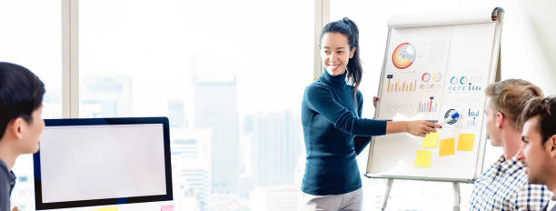 istock Confident woman pressenting financial chart in office meeting 1029036004
