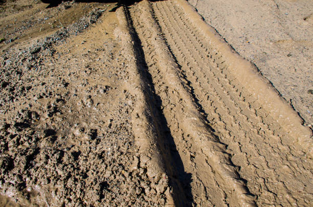 Wheel trail on sandy ground from large transport, tractor on construction site, sandy road. High quality photo