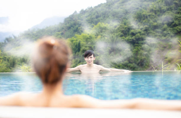 istock Young asian couple relaxing in hot springs 1029042162