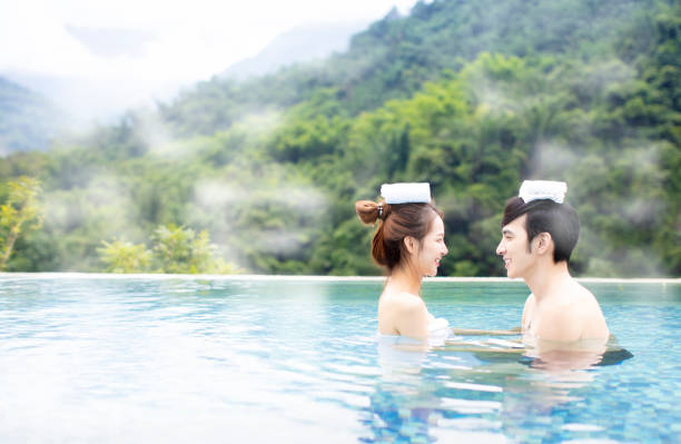 istock Young asian couple relaxing in hot springs 1029042232