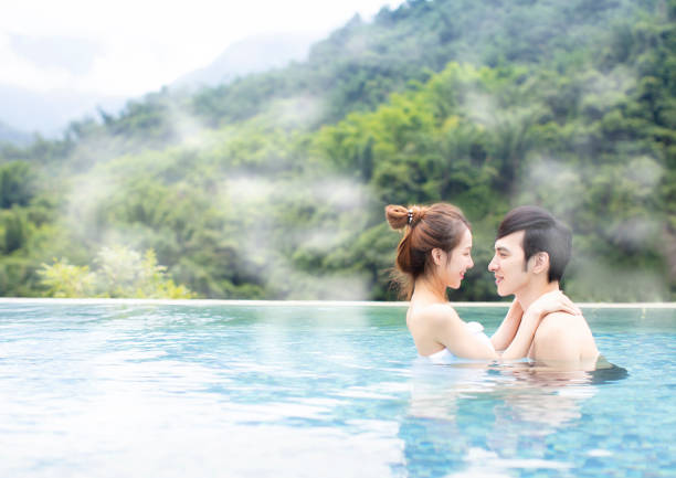 istock Young asian couple relaxing in hot springs 1029042234