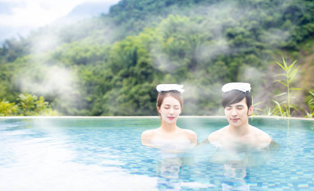 istock Young asian couple relaxing in hot springs 1029044286