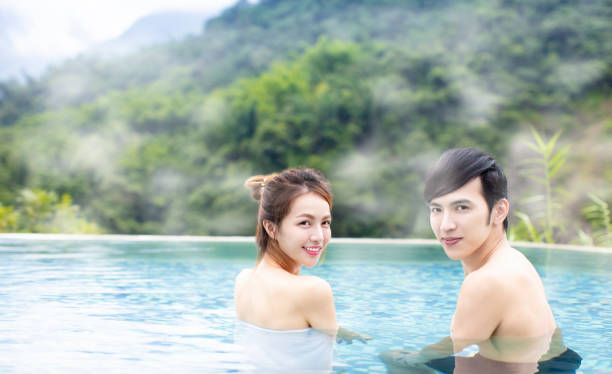 istock Young asian couple relaxing in hot springs 1029044360