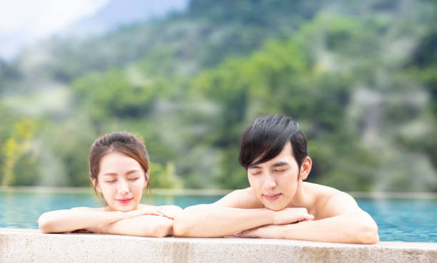 istock Young couple relaxing in hot springs 1029044388