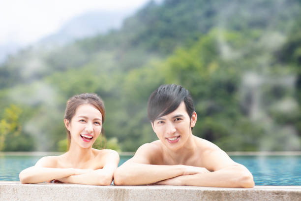 istock Young asian couple  in hot springs 1029044464