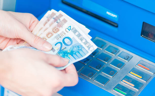 istock Close-up of hands counting Euro bills withdrawn from ATM. 1029069268