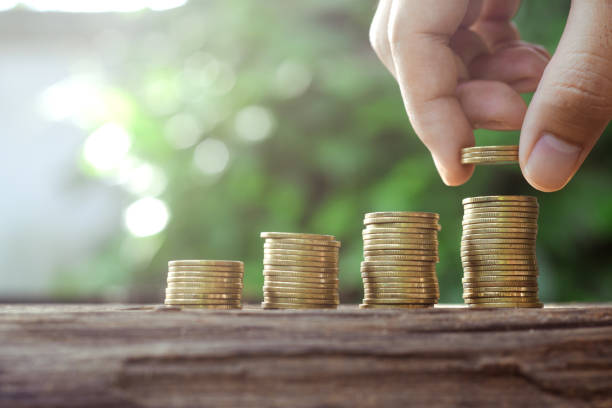 istock Saving money concept with Hand putting money coin stack growing business 1029074760