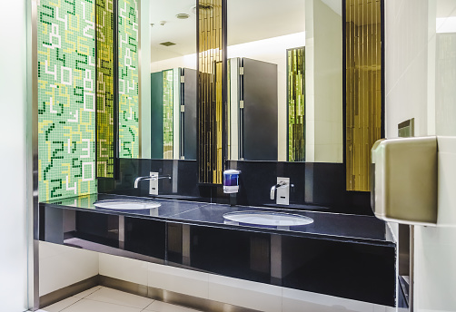 It consists of new mirror, ceramic washbasins, granite countertop, liquid soap and toilet paper roll holder.