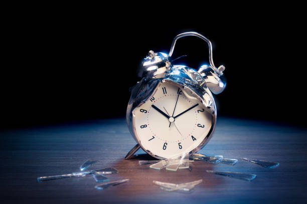istock Alarm clock with broken glass on dark background 1029082356