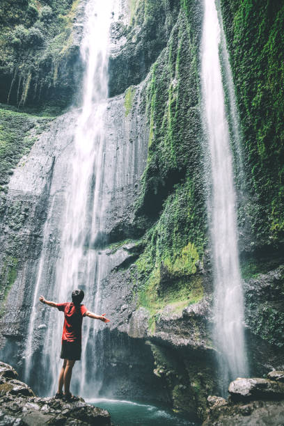 istock Travel Man Adventure and standing relaxation at Madakaripura waterfall East Java,IndonesiaIndonesia 1029085200