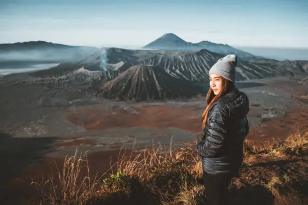 Traveler women and sunrise at volcano Mt.Bromo (Gunung Bromo) Kingkong hill East Java,Indonesia
