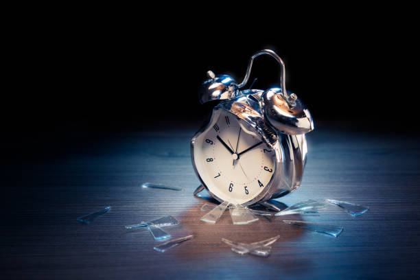 istock Alarm clock with broken glass on dark background 1029087448