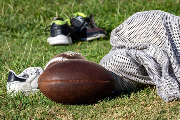 istock Football gear laying on practice field 1029087520