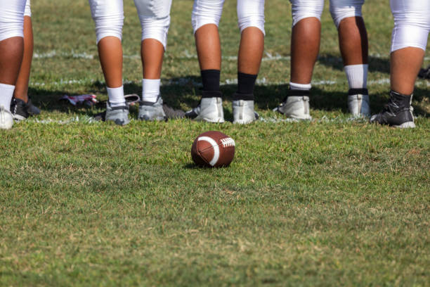 Football players ready for the game Football placed on field – Players getting ready for the game secondary school activities stock pictures, royalty-free photos & images