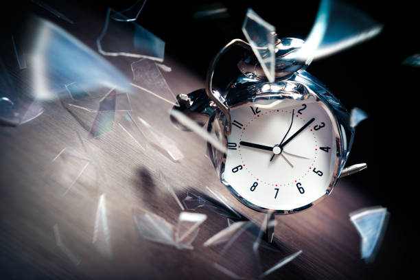 istock Alarm clock with broken glass on dark background 1029090448