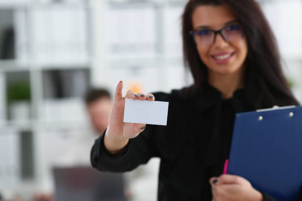 istock Female arm give blank calling card to visitor 1029109866
