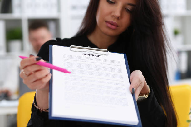 istock Female arm offer contract form on clipboard pad 1029109950