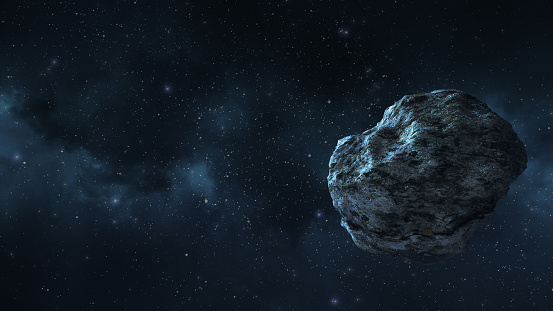 un asteroide o un meteorito vuela en el espacio, en el contexto de las nebulosas photo