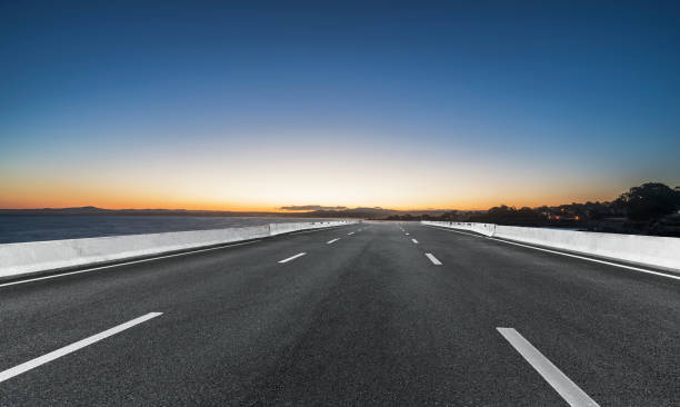 istock empty coastal highway against sea and sunset sky 1029124770