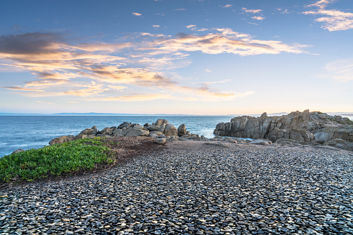 rocks in the water of the Mediterranean Sea, the water is blue and the sky is clear