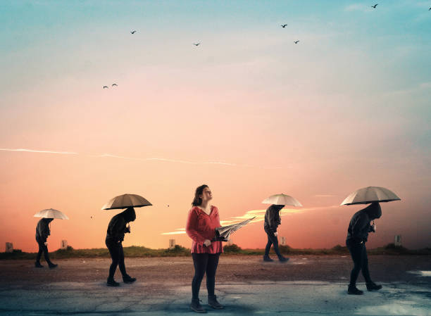 istock People with umbrella walking in a row and one noticed it was not raining 1029128238
