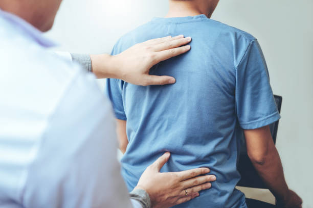istock Doctor consulting with patient Back problems Physical therapy concept 1029146878