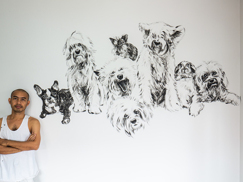 Painter artist with painting group of dogs with rabbit, black and white acrylic on gray cement wall background.for decoration or the memorial of pet with owner.