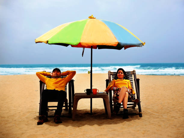 istock Resting couple on Calangute beach, Goa 1029155052