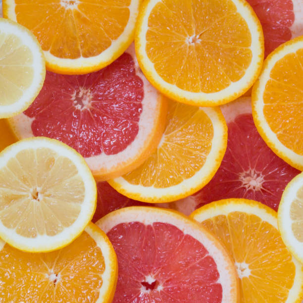 istock Sliced juicy orange, lemon, grapefruit and mandarin background 1029155084