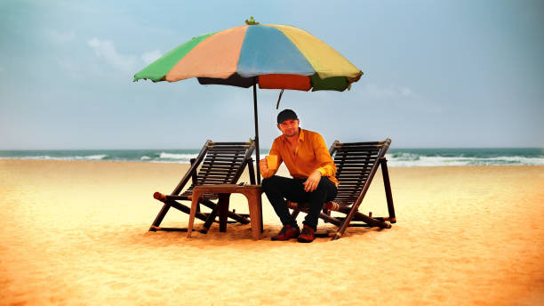 istock Young man enjoying hot coffee on tropical sandy beach, Goa 1029164134