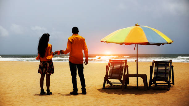 istock Couple enjoying hot coffee on Calangute beach, Goa 1029166714