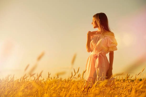istock Woman in wheat field at sunset 1029167430