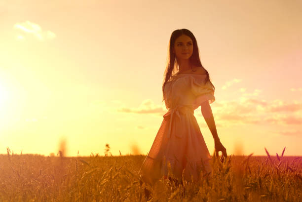 istock Woman in wheat field at sunset 1029167646