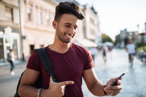 istock Young Middle Eastern tourist using new model of smart phone 1029169064