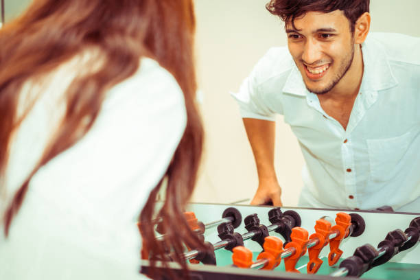 istock Happy couple playing foosball table. 1029172710
