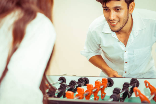 istock Happy couple playing foosball table. 1029172712