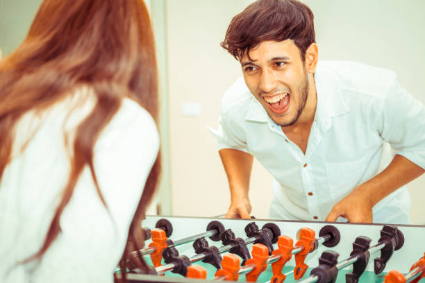istock Happy couple playing foosball table. 1029172718