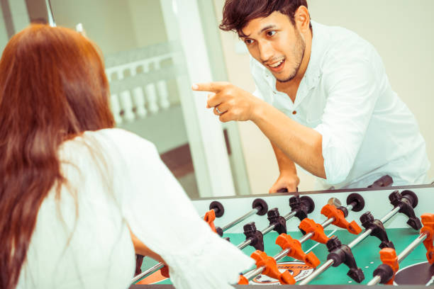 istock Happy couple playing foosball table. 1029172754