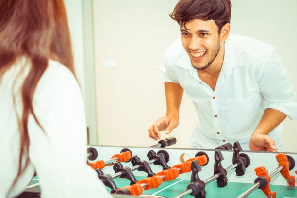istock Happy couple playing foosball table. 1029172762