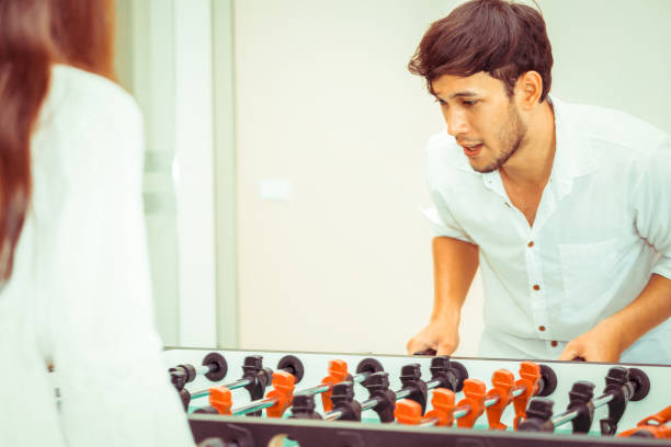 istock Happy couple playing foosball table. 1029172776