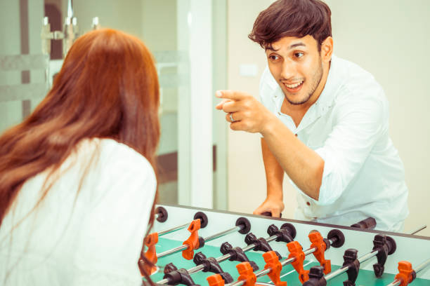 istock Happy couple playing foosball table. 1029172842