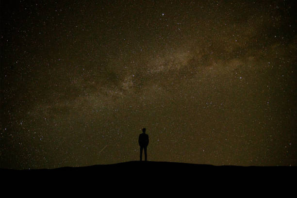 istock The man standing on the starry sky background 1029173518