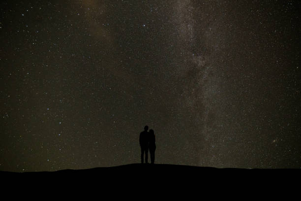 istock The couple standing on the starry sky background 1029173574
