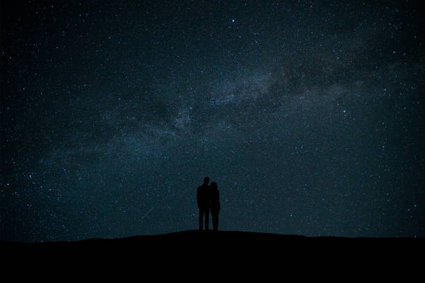 istock The couple standing on the sky with stars background 1029173598