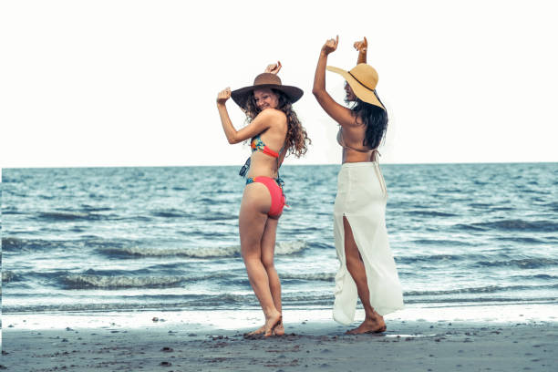 istock Happy women dance on sand beach in summer. 1029175684