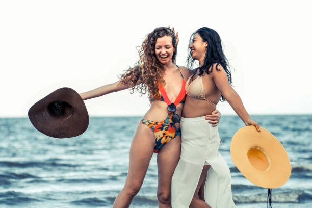 istock Happy women dance on sand beach in summer. 1029175718