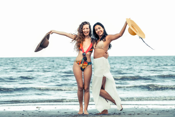 istock Happy women dance on sand beach in summer. 1029175724