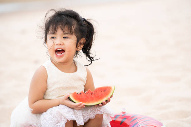 istock Adorable kid eating watermelon on the beach. 1029175770