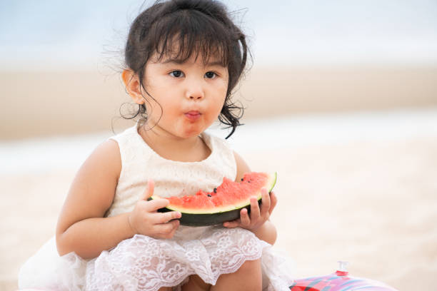 istock Adorable kid eating watermelon on the beach. 1029175818