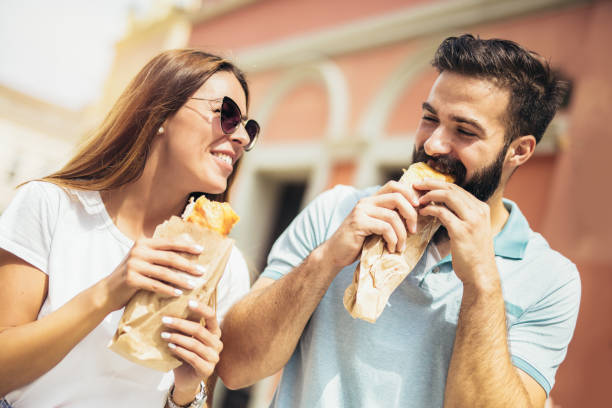 istock Young couple is eating sandwiches and having a great time 1029176444